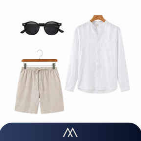 Look masculino Amalvi com camisa de linho branca, short de linho bege e óculos de sol modernos